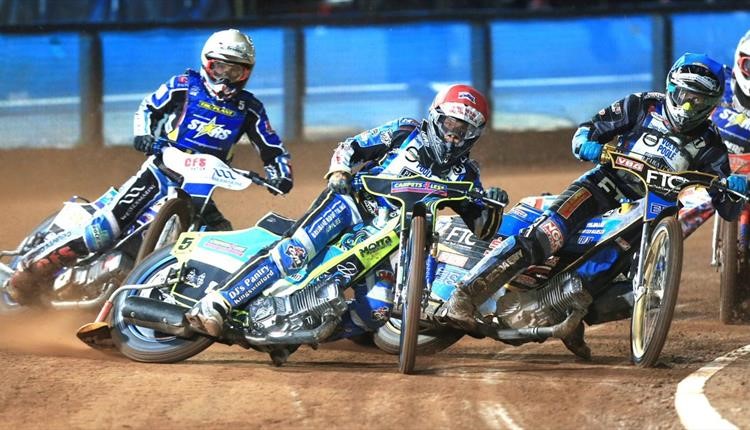 Poole Pirates Speedway drivers skidding round a corner at a race 